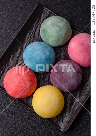 Japanese mochi, ice cream or Asian sweets with fruit filling. Mochi of different colors 132347322