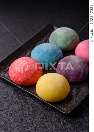 Japanese mochi, ice cream or Asian sweets with fruit filling. Mochi of different colors 132347323
