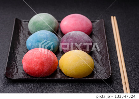 Japanese mochi, ice cream or Asian sweets with fruit filling. Mochi of different colors 132347324