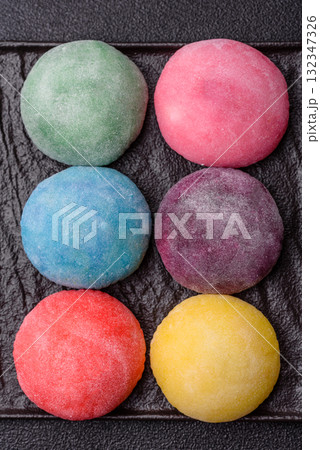 Japanese mochi, ice cream or Asian sweets with fruit filling. Mochi of different colors 132347326