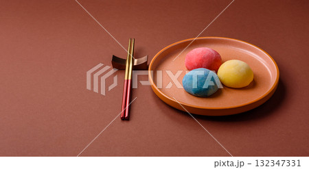 Japanese mochi, ice cream or Asian sweets with fruit filling. Mochi of different colors 132347331