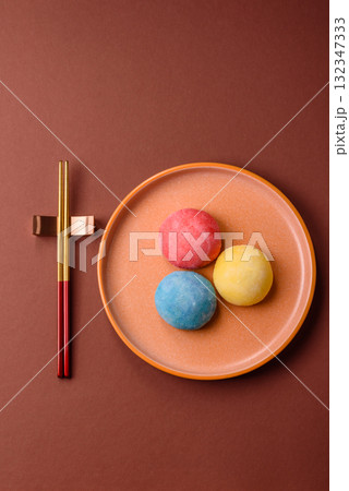 Japanese mochi, ice cream or Asian sweets with fruit filling. Mochi of different colors Japanese mochi, ice cream or Asian sweets with fruit filling. Mochi of different colors 132347333