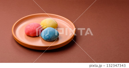 Japanese mochi, ice cream or Asian sweets with fruit filling. Mochi of different colors 132347343