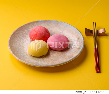 Japanese mochi, ice cream or Asian sweets with fruit filling. Mochi of different colors 132347350