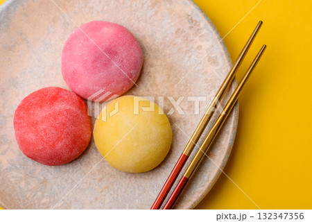 Japanese mochi, ice cream or Asian sweets with fruit filling. Mochi of different colors 132347356