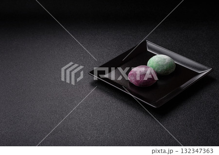 Japanese mochi, ice cream or Asian sweets with fruit filling. Mochi of different colors Japanese mochi, ice cream or Asian sweets with fruit filling. Mochi of different colors 132347363