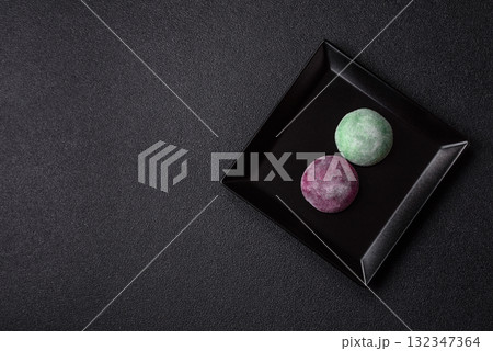 Japanese mochi, ice cream or Asian sweets with fruit filling. Mochi of different colors 132347364