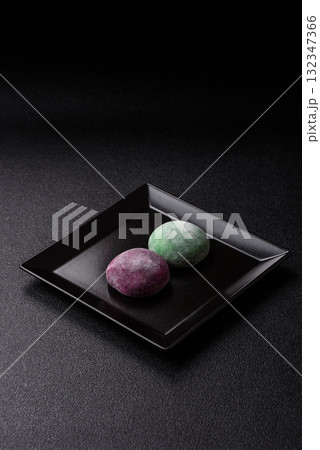Japanese mochi, ice cream or Asian sweets with fruit filling. Mochi of different colors Japanese mochi, ice cream or Asian sweets with fruit filling. Mochi of different colors 132347366