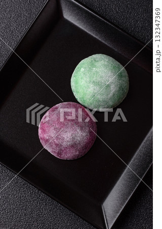 Japanese mochi, ice cream or Asian sweets with fruit filling. Mochi of different colors Japanese mochi, ice cream or Asian sweets with fruit filling. Mochi of different colors 132347369