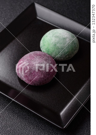 Japanese mochi, ice cream or Asian sweets with fruit filling. Mochi of different colors Japanese mochi, ice cream or Asian sweets with fruit filling. Mochi of different colors 132347370