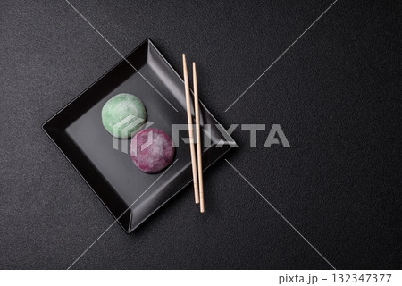 Japanese mochi, ice cream or Asian sweets with fruit filling. Mochi of different colors 132347377