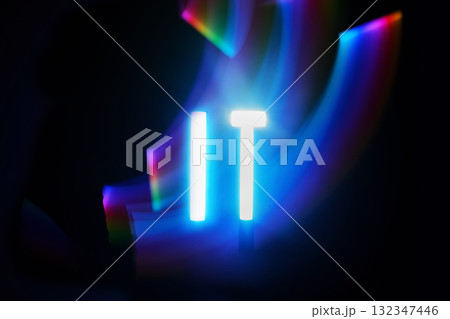 Illuminated IT. Neon 'IT' text with vibrant light trails in the dark Illuminated IT. Neon 'IT' text with vibrant light trails in the dark 132347446