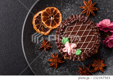 Sweet tart, pie with chocolate and cream with fruit filling on a plate. Chocolate tart Sweet tart, pie with chocolate and cream with fruit filling on a plate. Chocolate tart 132347563