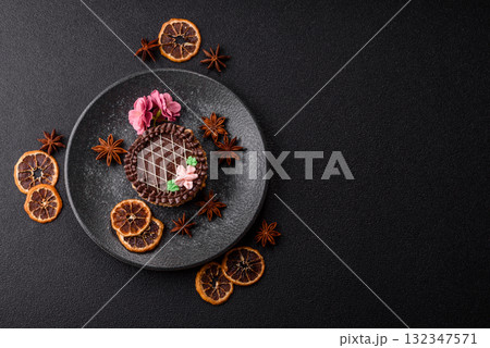 Sweet tart, pie with chocolate and cream with fruit filling on a plate. Chocolate tart Sweet tart, pie with chocolate and cream with fruit filling on a plate. Chocolate tart 132347571