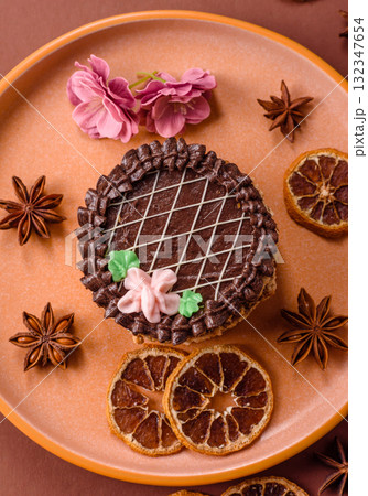 Sweet tart, pie with chocolate and cream with fruit filling on a plate. Chocolate tart 132347654