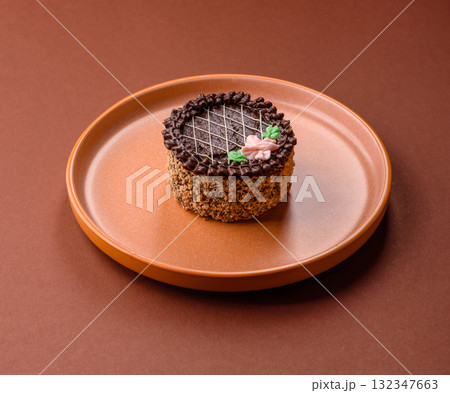 Sweet tart, pie with chocolate and cream with fruit filling on a plate. Chocolate tart Sweet tart, pie with chocolate and cream with fruit filling on a plate. Chocolate tart 132347663