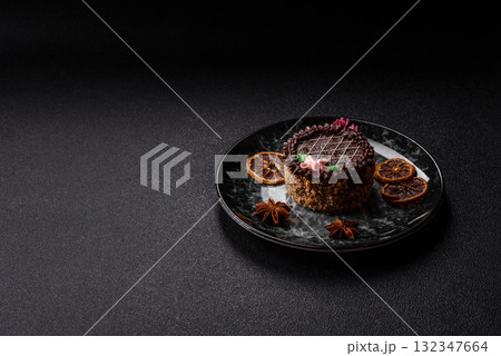 Sweet tart, pie with chocolate and cream with fruit filling on a plate. Chocolate tart Sweet tart, pie with chocolate and cream with fruit filling on a plate. Chocolate tart 132347664