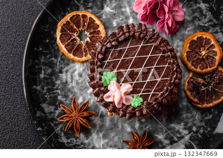 Sweet tart, pie with chocolate and cream with fruit filling on a plate. Chocolate tart Sweet tart, pie with chocolate and cream with fruit filling on a plate. Chocolate tart 132347669
