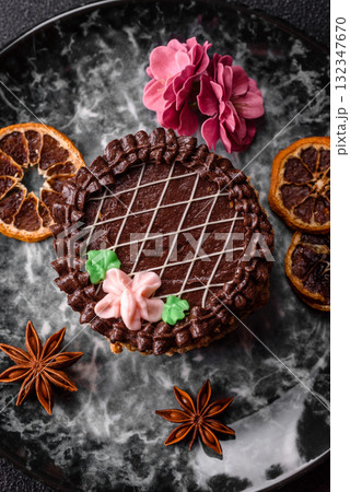 Sweet tart, pie with chocolate and cream with fruit filling on a plate. Chocolate tart Sweet tart, pie with chocolate and cream with fruit filling on a plate. Chocolate tart 132347670