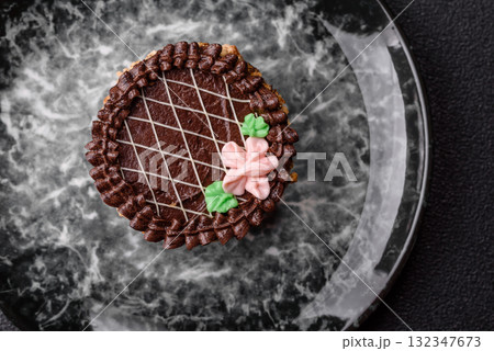 Sweet tart, pie with chocolate and cream with fruit filling on a plate. Chocolate tart Sweet tart, pie with chocolate and cream with fruit filling on a plate. Chocolate tart 132347673