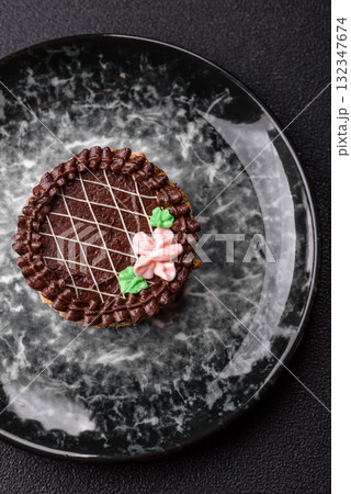 Sweet tart, pie with chocolate and cream with fruit filling on a plate. Chocolate tart Sweet tart, pie with chocolate and cream with fruit filling on a plate. Chocolate tart 132347674