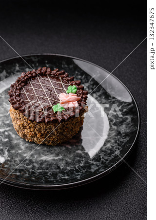 Sweet tart, pie with chocolate and cream with fruit filling on a plate. Chocolate tart Sweet tart, pie with chocolate and cream with fruit filling on a plate. Chocolate tart 132347675