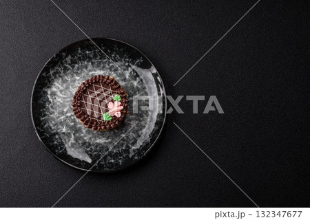 Sweet tart, pie with chocolate and cream with fruit filling on a plate. Chocolate tart Sweet tart, pie with chocolate and cream with fruit filling on a plate. Chocolate tart 132347677