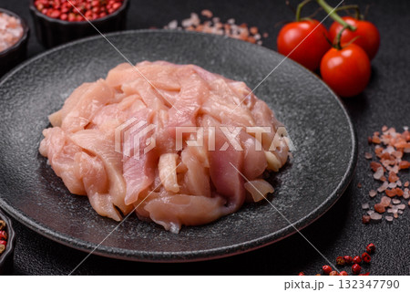 Raw chicken meat cut into strips, fresh fillet or breast slices. Chicken raw meat in pieces 132347790