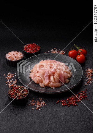 Raw chicken meat cut into strips, fresh fillet or breast slices. Chicken raw meat in pieces 132347797