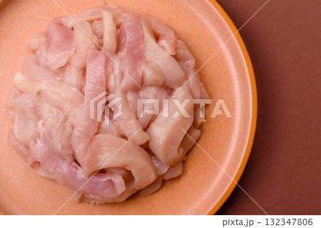 Raw chicken meat cut into strips, fresh fillet or breast slices. Chicken raw meat in pieces 132347806