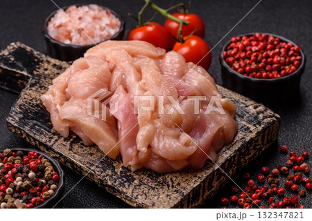Raw chicken meat cut into strips, fresh fillet or breast slices. Chicken raw meat in pieces 132347821