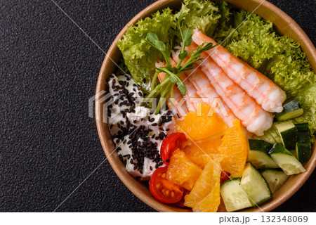 Bowl with shrimps, seafood, rice, oranges, tomatoes with sauce. Bowl with prawns Bowl with shrimps, seafood, rice, oranges, tomatoes with sauce. Bowl with prawns 132348069