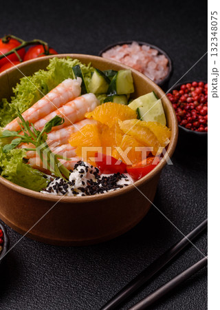 Bowl with shrimps, seafood, rice, oranges, tomatoes with sauce. Bowl with prawns Bowl with shrimps, seafood, rice, oranges, tomatoes with sauce. Bowl with prawns 132348075