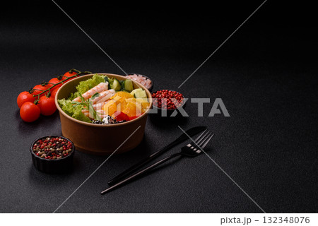 Bowl with shrimps, seafood, rice, oranges, tomatoes with sauce. Bowl with prawns 132348076