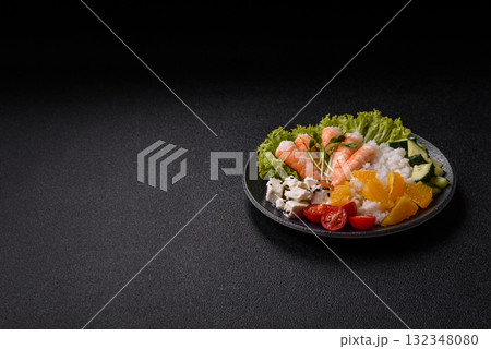 Bowl with shrimps, seafood, rice, oranges, tomatoes with sauce. Bowl with prawns Bowl with shrimps, seafood, rice, oranges, tomatoes with sauce. Bowl with prawns 132348080