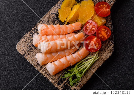 Bowl with shrimps, seafood, rice, oranges, tomatoes with sauce. Bowl with prawns Bowl with shrimps, seafood, rice, oranges, tomatoes with sauce. Bowl with prawns 132348115
