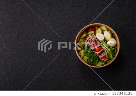 Seafood bowl, tuna tataki fillet slices with rice, oranges, tomatoes and sauce. Tuna bowl Seafood bowl, tuna tataki fillet slices with rice, oranges, tomatoes and sauce. Tuna bowl 132348126