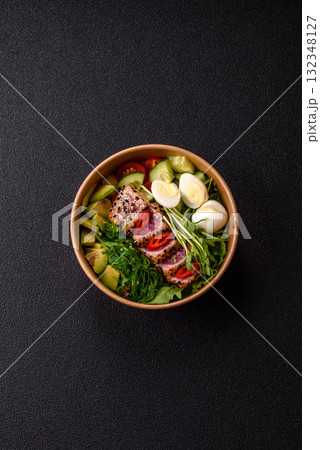 Seafood bowl, tuna tataki fillet slices with rice, oranges, tomatoes and sauce. Tuna bowl Seafood bowl, tuna tataki fillet slices with rice, oranges, tomatoes and sauce. Tuna bowl 132348127