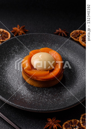 Pie, sweet round tart with apricot pieces, cream and nuts. Sweet tart with peach 132348192