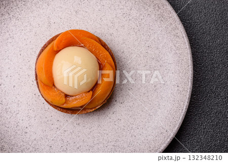 Pie, sweet round tart with apricot pieces, cream and nuts. Sweet tart with peach 132348210