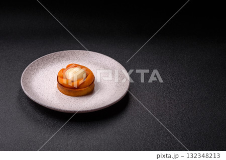 Pie, sweet round tart with apricot pieces, cream and nuts. Sweet tart with peach 132348213