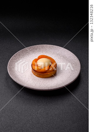 Pie, sweet round tart with apricot pieces, cream and nuts. Sweet tart with peach 132348216