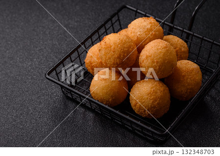 Cheese balls, croquettes or arancini with potatoes or rice. Cheese balls 132348703