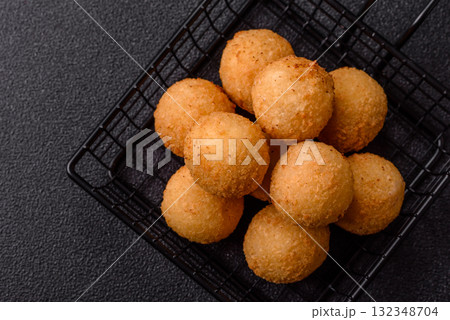 Cheese balls, croquettes or arancini with potatoes or rice. Cheese balls 132348704