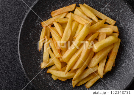 French fries, chips or snack with sauce as food background. French fries 132348751