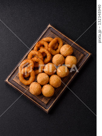 Fast food, cheese balls, onion or squid rings and French fries. Junk food as a background Fast food, cheese balls, onion or squid rings and French fries. Junk food as a background 132348940