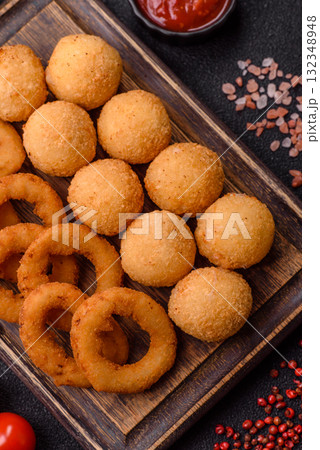 Fast food, cheese balls, onion or squid rings and French fries. Junk food as a background Fast food, cheese balls, onion or squid rings and French fries. Junk food as a background 132348948