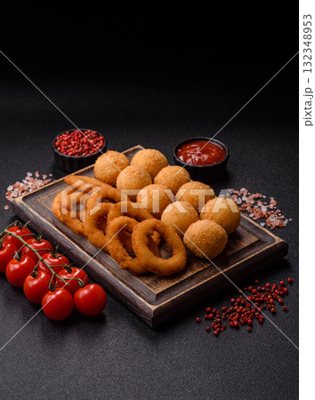 Fast food, cheese balls, onion or squid rings and French fries. Junk food as a background Fast food, cheese balls, onion or squid rings and French fries. Junk food as a background 132348953