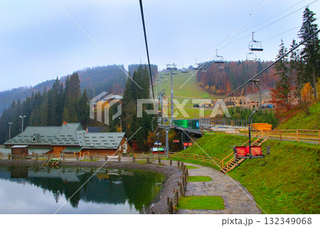 Picturesque lake and tourist houses in ukrainian ski Bukovel. Landscape with mountain lake in resort town Picturesque lake and tourist houses in ukrainian ski Bukovel. Landscape with mountain lake in resort town 132349068