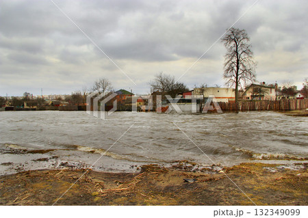 Flooding of river in spring in town during melting of snow. Natural disaster 132349099